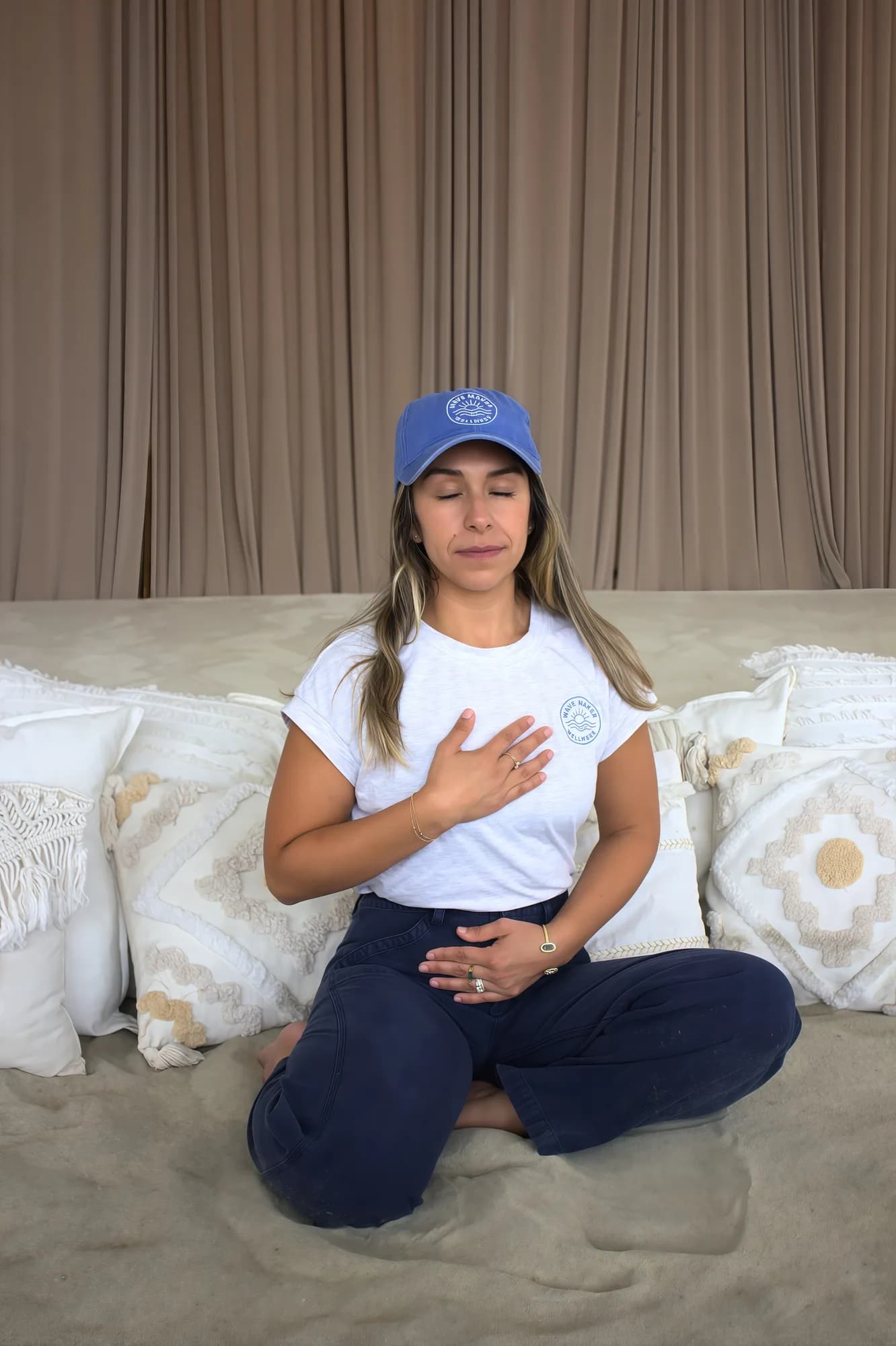 Sally sitting quietly with a hand on her heart